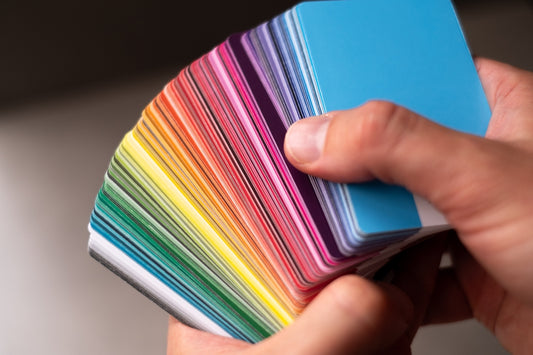 a person holding a colorful card in their hand
