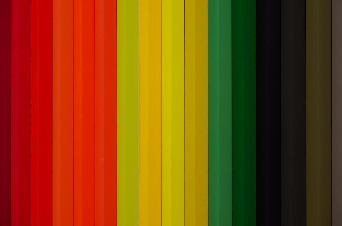 A spectrum of colored pencils arranged vertically.
