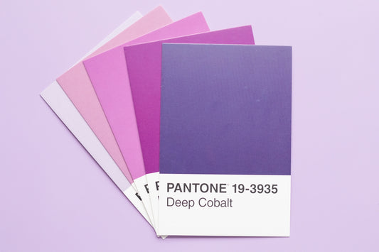 Fan of pantone color swatches from pink to deep cobalt.