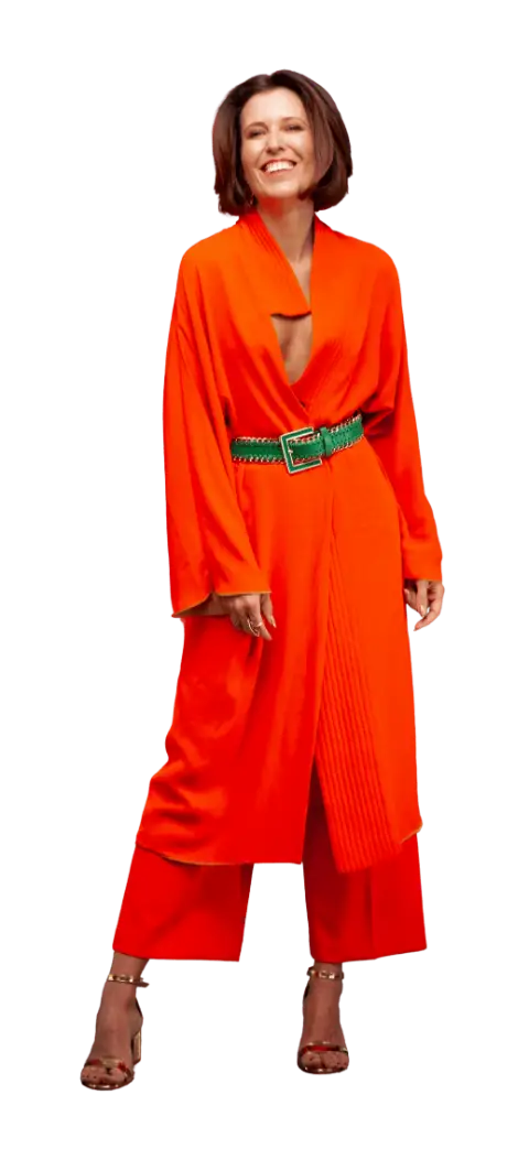 Sissa Germann, founder of Drops de Cor, in a bright orange outfit